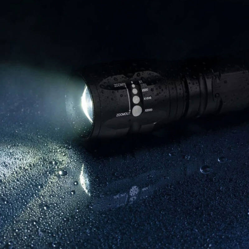 active flashlight on a wet floor in a dark room 1